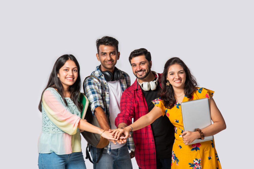 Asian Indian smart college students posing for a photo against white background