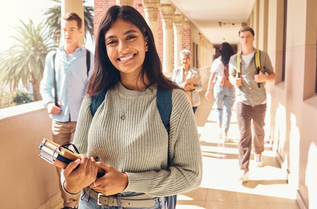 University student, indian woman and portrait at campus outdoor with books of learning, education o