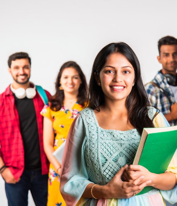 Asian Indian smart college students posing for a photo against white background
